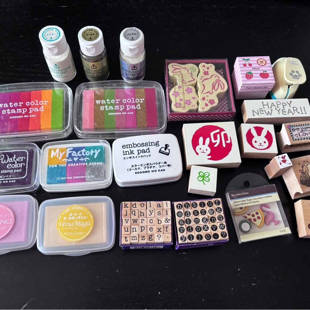 Collection of stamps, stamp pads, and other craft supplies